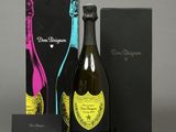 a bottle of champagne and a box of wine on a table