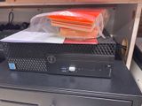 a black computer sitting on top of a black desk