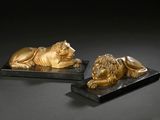 pair of bronze lions on black marble bases