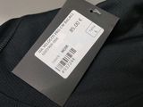 a label on the back of a black shirt