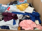 a cardboard box full of clothes in a store