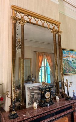 a large mirror on a mantle in a room