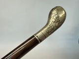 a close up of a walking stick with a picture of a woman on it