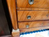 a wooden dresser with three drawers on top of it