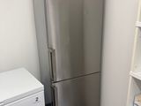 a silver refrigerator and a white refrigerator freezer in a room