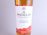 a bottle of macallan earth on a white background