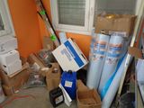 a pile of moving boxes and other items in a room