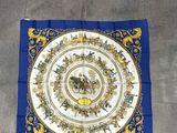 a blue and gold scarf with a picture of a horse and rider on it