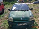 a green car that is parked in the grass