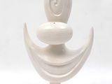 a white vase with a face on top of it