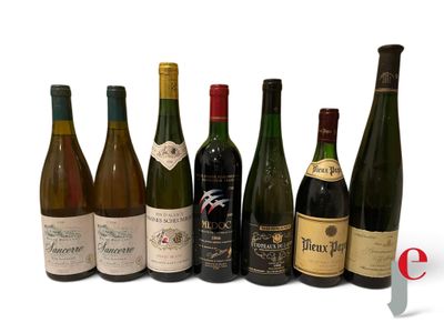 several bottles of wine are lined up in a row on a white surface