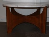 a marble table with a wooden base in a room