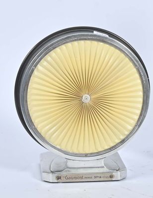 une horloge blanche posée sur un socle, sur une surface blanche