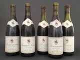 six bottles of wine are lined up in a row