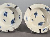une paire d'assiettes bleues et blanches ornées de fleurs, posées sur une table