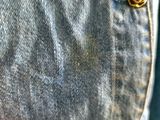 a close up of a button on a pair of jeans