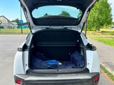 the back of a car with its trunk open in a parking lot