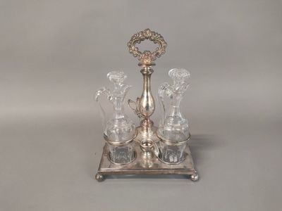 an image of a silver plate with four glasses and a candle holder