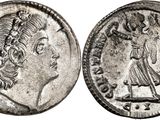 a silver coin with an image of a woman on it