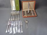 a box of silverware and a set of forks and spoons