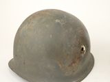 an old helmet on a white background with a hole in the side