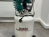 an air compressor sitting on top of a cart with a hose attached to it