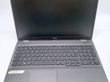 the laptop is open on a white surface with a black keyboard