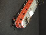 a red and white train that is on the tracks