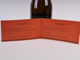 an image of a bottle of wine sitting on top of a table