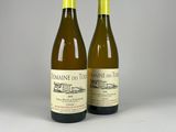 two bottles of wine sitting next to each other on a table