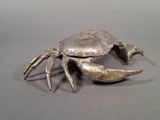 a silver crab that is sitting on a table