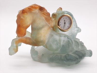 a figurine of a horse with a clock on its back
