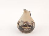 a small vase with a painting on it on a white surface