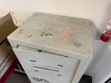 a white refrigerator with a metal door and a red drawer