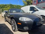 a picture of a black sports car parked in a parking lot