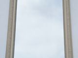 a mirror on the wall with a sky in the background