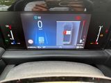 a picture of a car ' s dashboard with a digital display on it