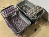 two baskets that are sitting on the floor next to each other