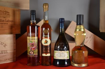 several bottles of wine are lined up on a red table