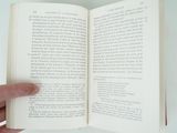 a person holding an open book in their hand
