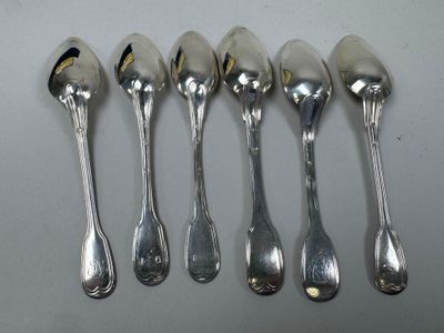 six spoons are lined up in a row on a table
