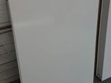 two white refrigerators sitting next to each other in a garage