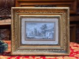 la photo d'une maison dans un cadre posé sur une table
