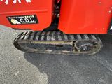 a close up of a red tractor with a black tire