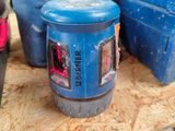 a blue canister sitting on top of a wooden table