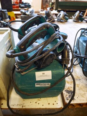 a green air compressor sitting on top of a table