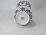 a blue and white vase sitting on a white surface