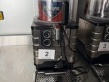 two coffee machines sitting on the counter in the kitchen