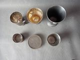 a table with cups of coffee and a cup of tea