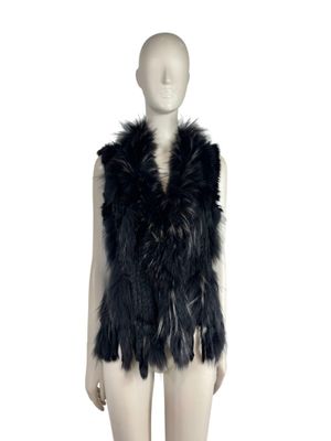 the mannequin is wearing a black fur vest and black boots